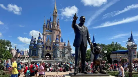 Reuters People gather at the Magic Kingdom theme park at Walt Disney World in Florida, the United States, July 30, 2022.