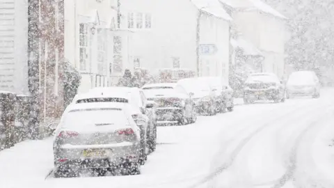 PA Media Cars parked during a snow flurry in Lenham, Kent