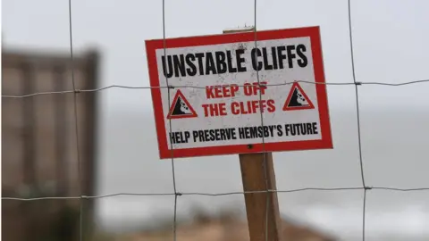 PA Media unstable cliff sign in Hemsby