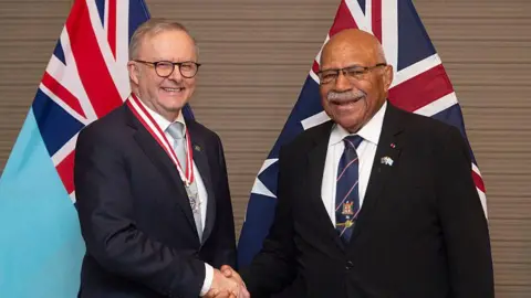 Australian Prime Minister Anthony Albanese (L) shakes hands with Fiji's Prime Minister Sitiveni Rabuka (R)