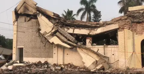 BBC Urdu A damaged building, with its ceiling collapsed