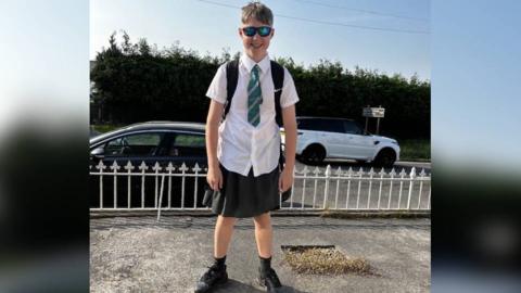 Oscar wearing a skirt to school