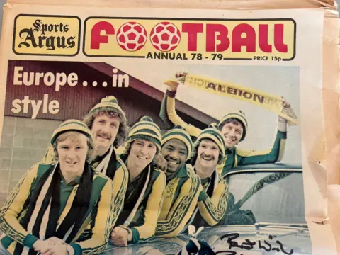 Norman Bartlam The front cover of a Sports Argus special annual featuring players from West Bromwich Albion in yellow and green strips with knitted bobble hats on