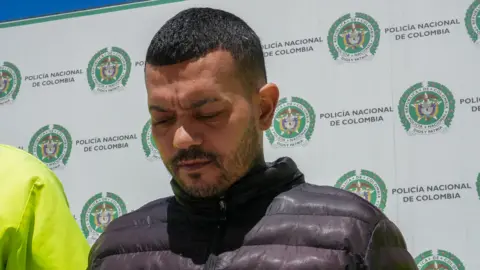 Reuters Elder Jose Arteaga Hernandez has dwncast eyes and wears a black puffa jacket.