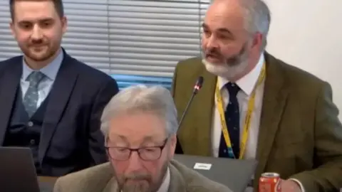 Herefordshire Council Councillor Nick Mason (right) with fellow Herefordshire councillors Dan Hurcomb (left) and Barry Durkin (front). Mason is wearing a yellow lanyard.