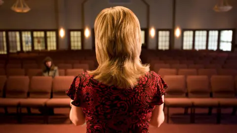 Stock image of woman in church