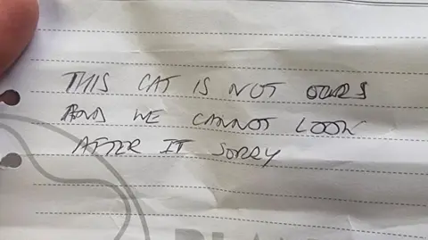 RSPCA Coventry & District Branch A handwritten note that says 'This cat is not ours and we cannot look after it sorry'.