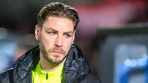 Sam Foley looks on during Barrow's defeat by Salford City