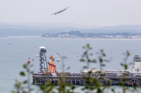 Paul Johnson - Flightline An Avro Lancaster aircraft flying over Bournemouth Pier