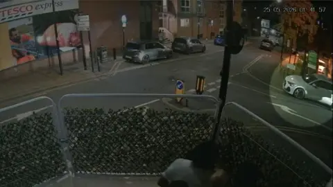South Yorkshire Police CCTV image showing a white Audi highlighted, parked at a junction opposite Tesco Express