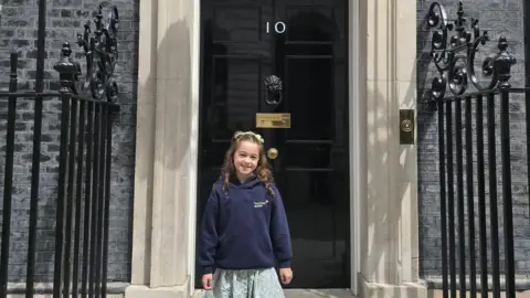 Family Handout Freya stands in front of the door at 10 Downing Street where she hand delivered a letter to the Prime Minister detailing her life living with Tourettes Syndrome. 