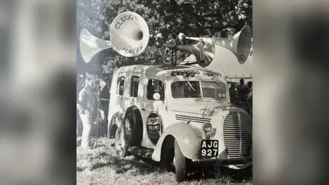 Clegg family A black and white photo of a van from the 1940s with speakers on the top 