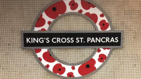 Getty Images A London Underground roundel is modified with poppies, at King"s Cross St Pancras station