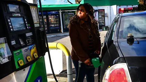 Getty Images Woman at petrol pump