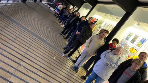 Forbidden Planet A group of people queuing outside the store