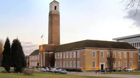 David Dixon/Geograph External view of Salford Civic Centre as the sun is setting.