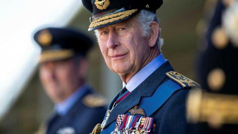 The King wearing RAF uniform, with a hat and medals 