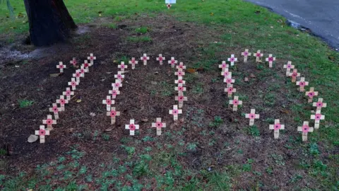 Reuters Wooden crosses are seen arranged to form the number one hundred to mark Remembrance on the grounds of St Mary's church in Isleworth, London