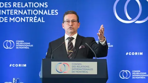 Getty Images Yves-Francois Blanchet, leader of the Bloc Quebecois party, wears a suit and speaks during an event at the Montreal Council on Foreign Relations in Montreal, Quebec, Canada, on Tuesday, Feb. 11, 2025.