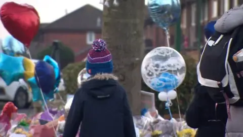 A child visiting the tributes left for the victims