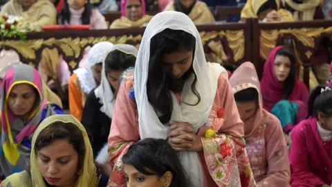 AFP Christian devotees attend Christmas Day prayers at St. Johns Cathedral Church in Peshawar