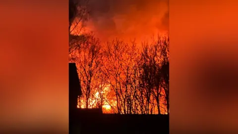 The fire, captured on a mobile phone from a distance.