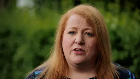 PA Media Naomi Long during canvassing in east Belfast where she was her party's candidate in the Westminster election