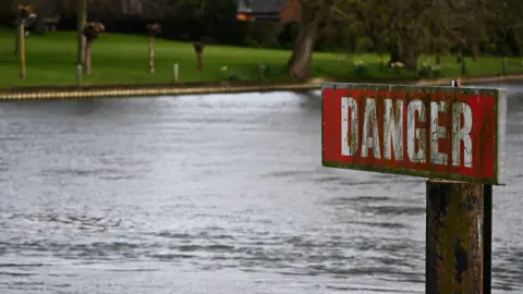 Reuters A sign reading "danger" next to the River Thames