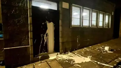 Image showing white paint thrown over the outside of a mosque building.