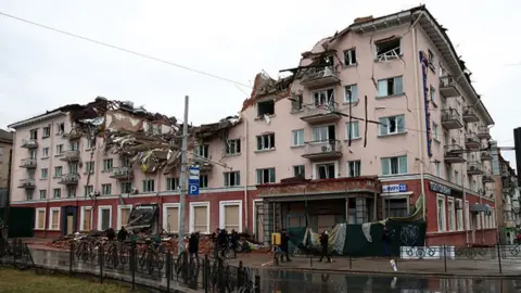 Getty Images The building of the Hotel Ukraine shows damage caused by Russian shelling in Chernihiv, northern Ukraine.