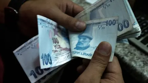 Man counting Turkish banknotes