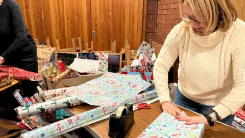 Woman wrapping up gifts