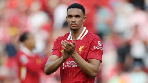 Trent Alexander-Arnold clapping his hands in a Liverpool shirt