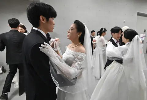 AFP Couples prepare for their performances at a mass wedding ceremony organised by the Unification Church in Gapyeong.