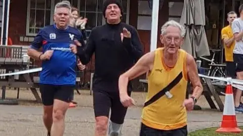 Leigh Kendall Ray Evans completing his 500th Parkrun