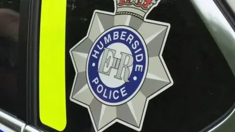 BBC Humberside Police badge on a police car