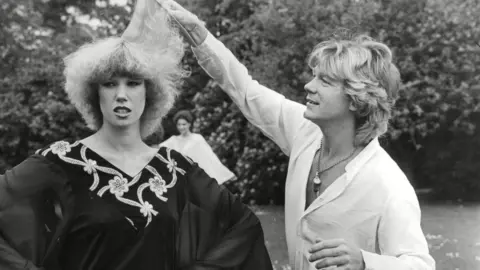 Hairdresser Pierre Alexandre styling the hair of model Lesley Palmer on a photo shoot