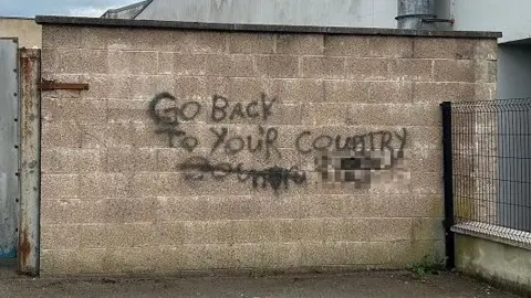Racist graffiti, partially blurred