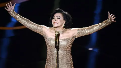 Getty Images Dame Shirley Bassey performs at the Oscars