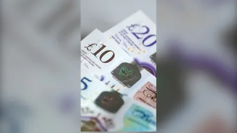 £5, £10 and £20 notes laid out together