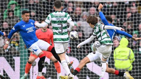 Celtic and Rangers players battle for the ball