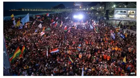 AFP Pilgrims gather on Copacabana Beach, Rio, for the launch of World Youth Day. 23 July 2013