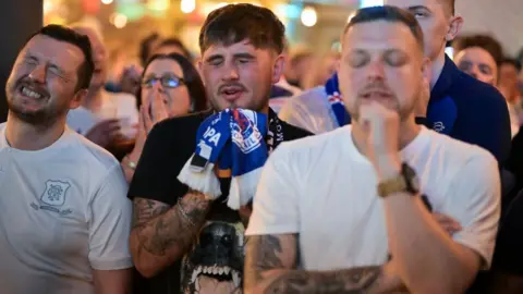 Getty Images Rangers fans watching the game