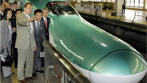 AFP Then-California Governor Arnold Schwarzenegger inspects bullet trains in Japan in 2010 as inspiration for California's own train updates