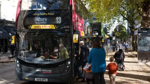 BBC People board a bus in Birmingham city centre 