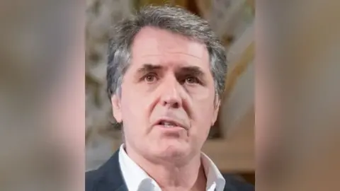 Liverpool City Region Combined Authority Liverpool City Region metro mayor Steve Rotheram with grey hair wearing a white shirt and black suit jacket.