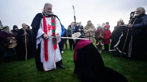 Ben Birchall/PA Man dressed in robes at Stonehenge