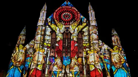 An image of ancient royals projected onto the façade of York Minster