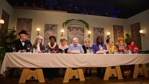 Sky UK Cast members of Saturday Night Live UK sit at a long table resembling the Last Supper, with an actor playing David Attenborough in the middle, and others including Freddie Mercury and Winston Churchill alongside him 