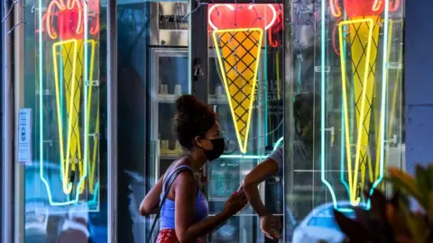 Getty Images Masks are worn to buy ice cream in Florida